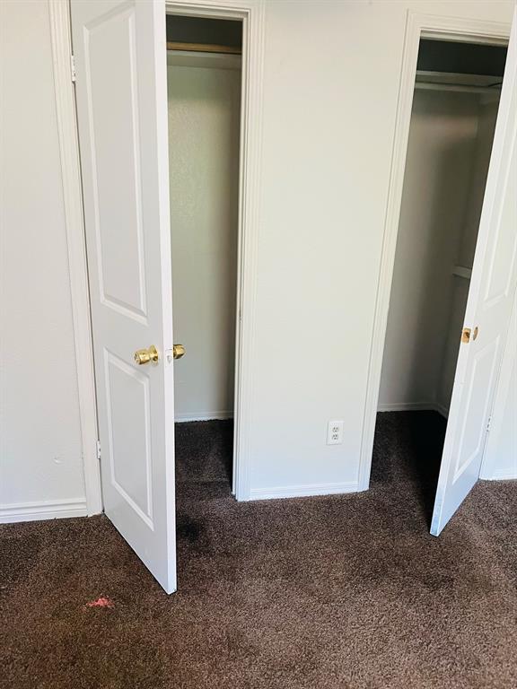 6320 Midway Road, Unit B Springtown, TX 76082 - Photo 13 of 19 Unfurnished bedroom featuring dark colored carpet and a spacious closet