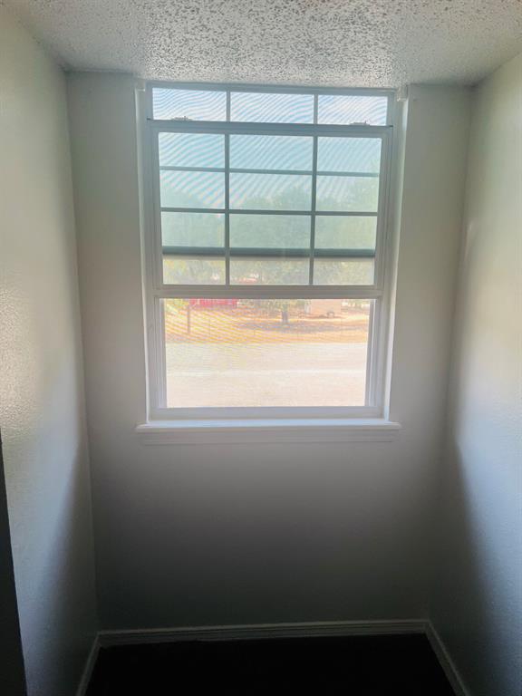 6320 Midway Road, Unit B Springtown, TX 76082 - Photo 18 of 19 Empty room featuring a textured ceiling