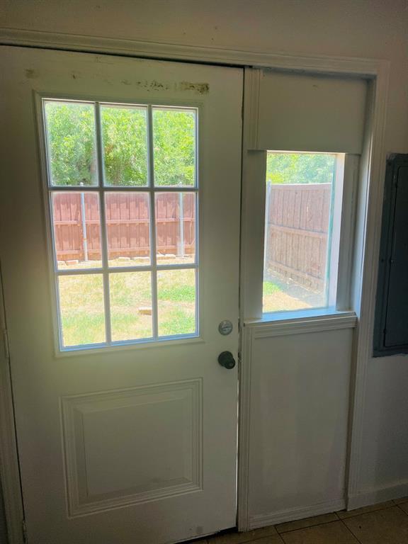 6320 Midway Road, Unit B Springtown, TX 76082 - Photo 4 of 19 Doorway to outside with tile patterned flooring and plenty of natural light