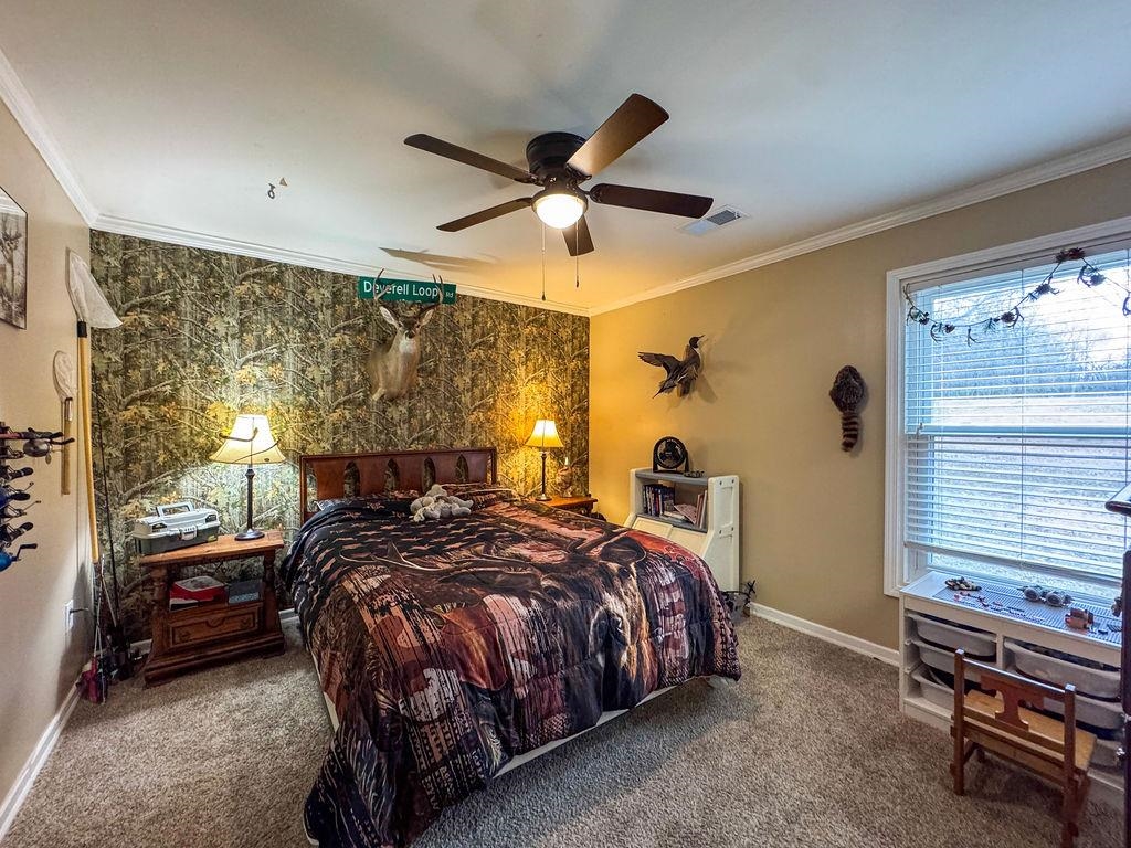 127 Walton Loop Covington, TN 38019 - Photo 29 of 40 a bedroom with a bed and a chandelier