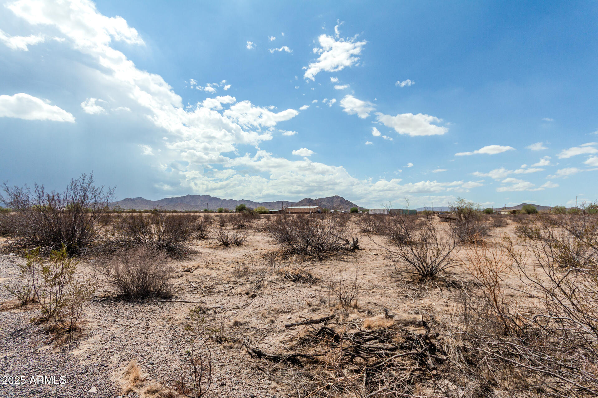 0 West Stallion Road, Unit 29 Maricopa, AZ 85139 - Photo 3 of 14 a view of a dry yard with mountains in the background