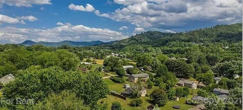 385 James Street Clyde, NC 28721 - Photo 11 of 14 a view of a city with lush green forest