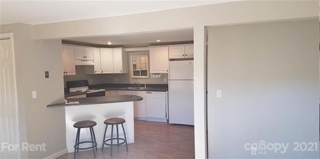 385 James Street Clyde, NC 28721 - Photo 3 of 14 a kitchen with a sink cabinets and wooden floor