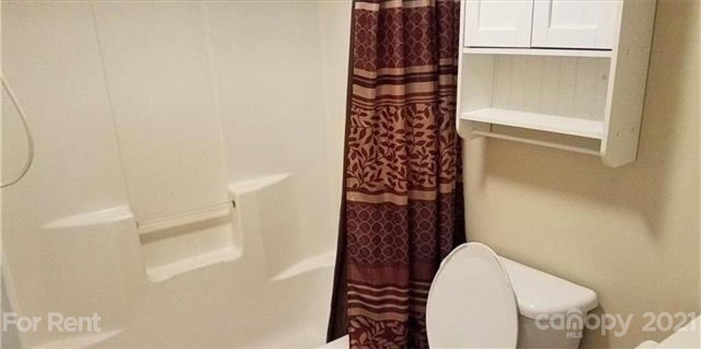 385 James Street Clyde, NC 28721 - Photo 6 of 14 a bathroom with a shower and a toilet