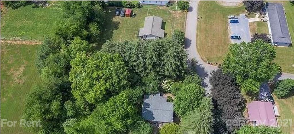 385 James Street Clyde, NC 28721 - Photo 10 of 14 an aerial view of a house with a yard and garden
