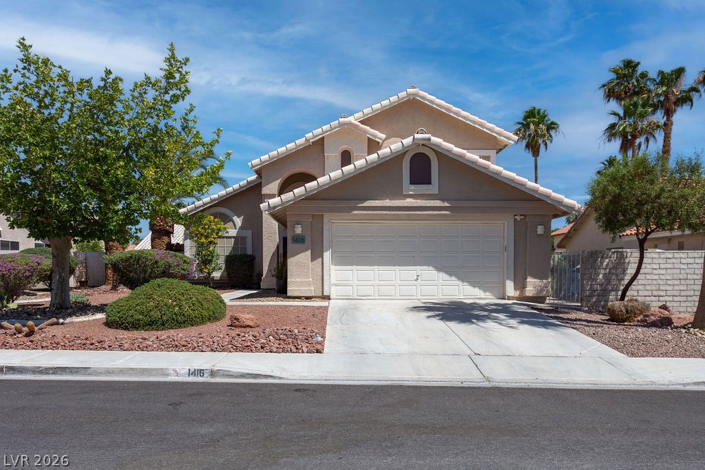 A well-maintained stucco facade with a two-car garage welcomes you home.