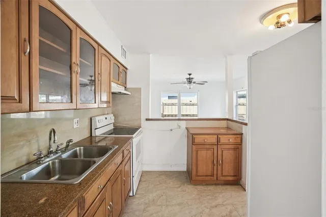 a kitchen that has a sink and cabinets