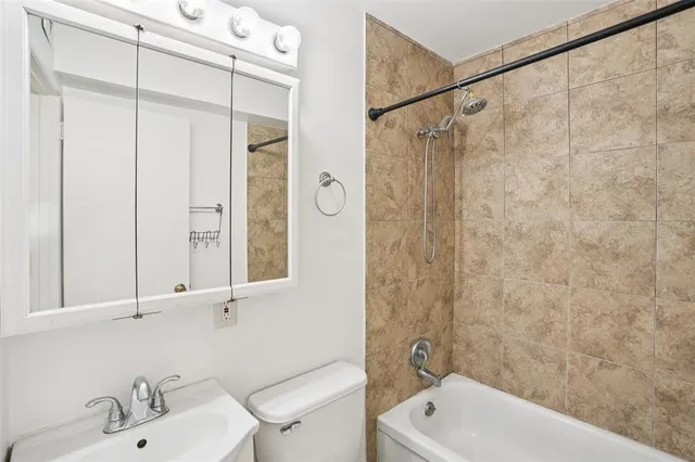 a bathroom with a shower and a sink