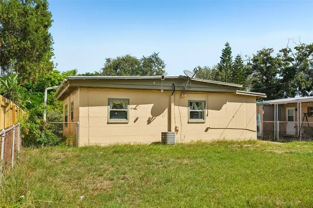 a white house that has tree in front of it