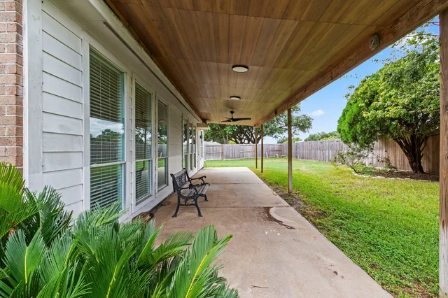 a view of a house with a yard and sitting area