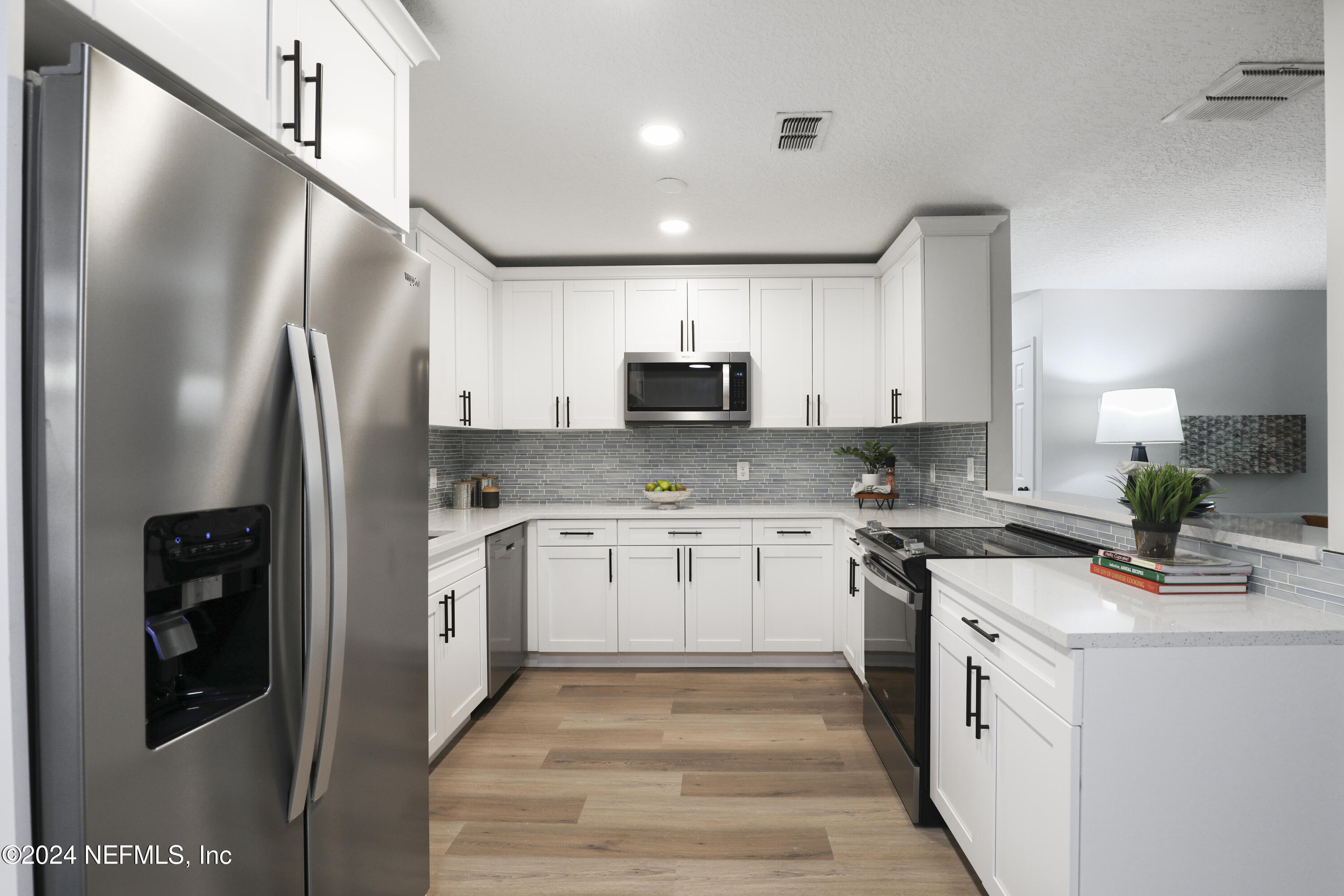 3917 Eunice Road Jacksonville, FL 32250 - Photo 21 of 71 a kitchen with stainless steel appliances granite countertop a refrigerator a stove and a sink
