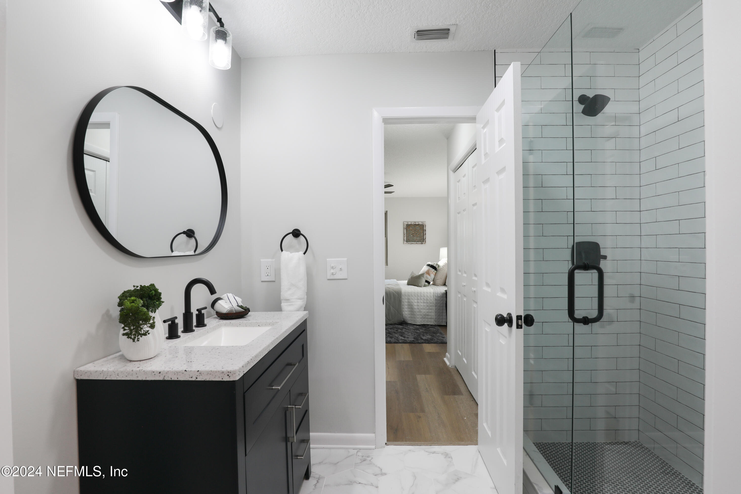 3917 Eunice Road Jacksonville, FL 32250 - Photo 27 of 71 a bathroom with a sink and a mirror