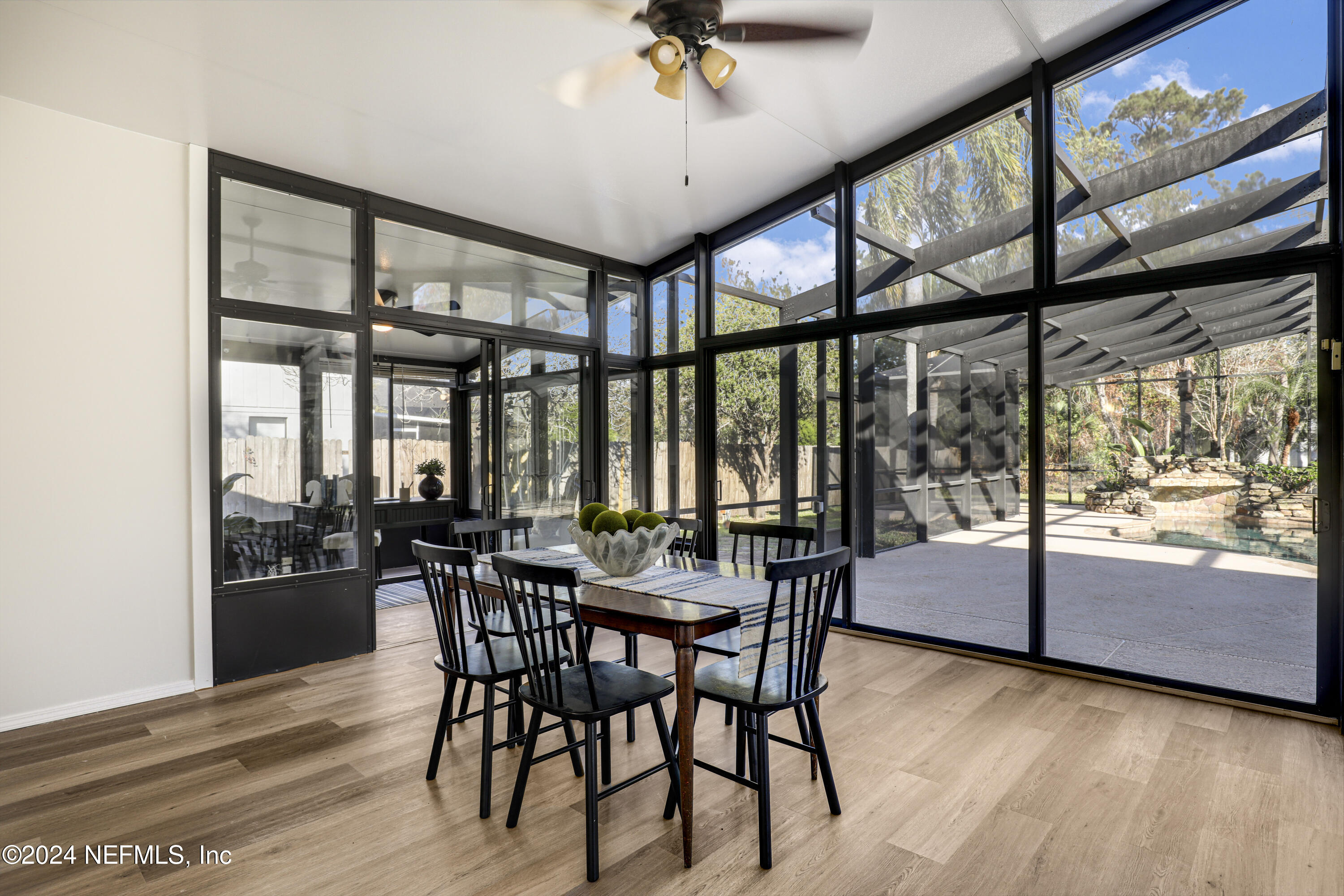 3917 Eunice Road Jacksonville, FL 32250 - Photo 37 of 71 a view of a dining room with furniture large windows and wooden floor