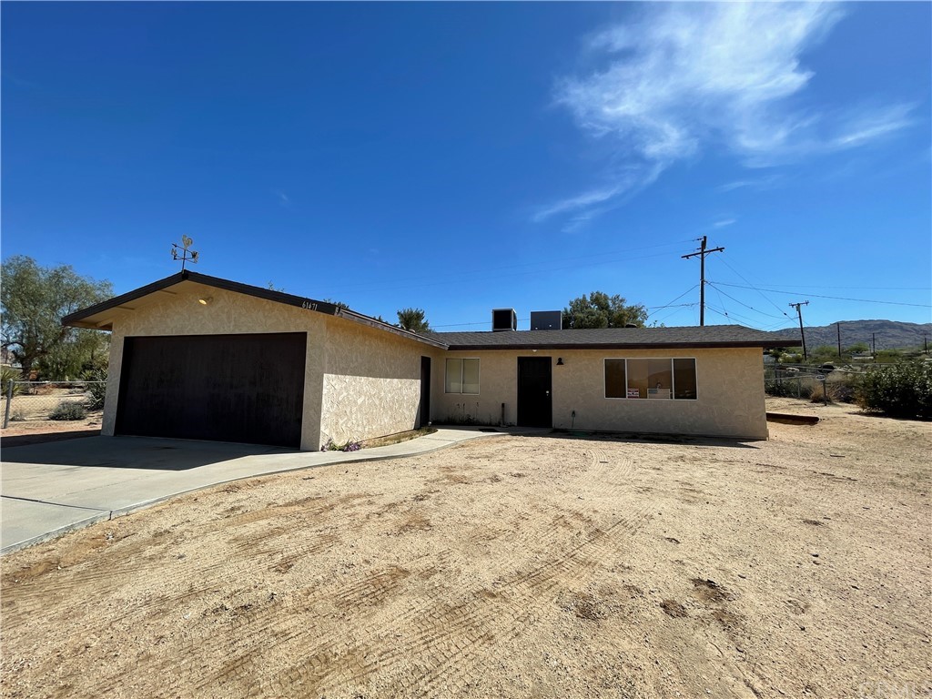 61471 El Cajon Drive Joshua Tree, CA 92252 - Photo 1 of 1 a front view of a house with a yard