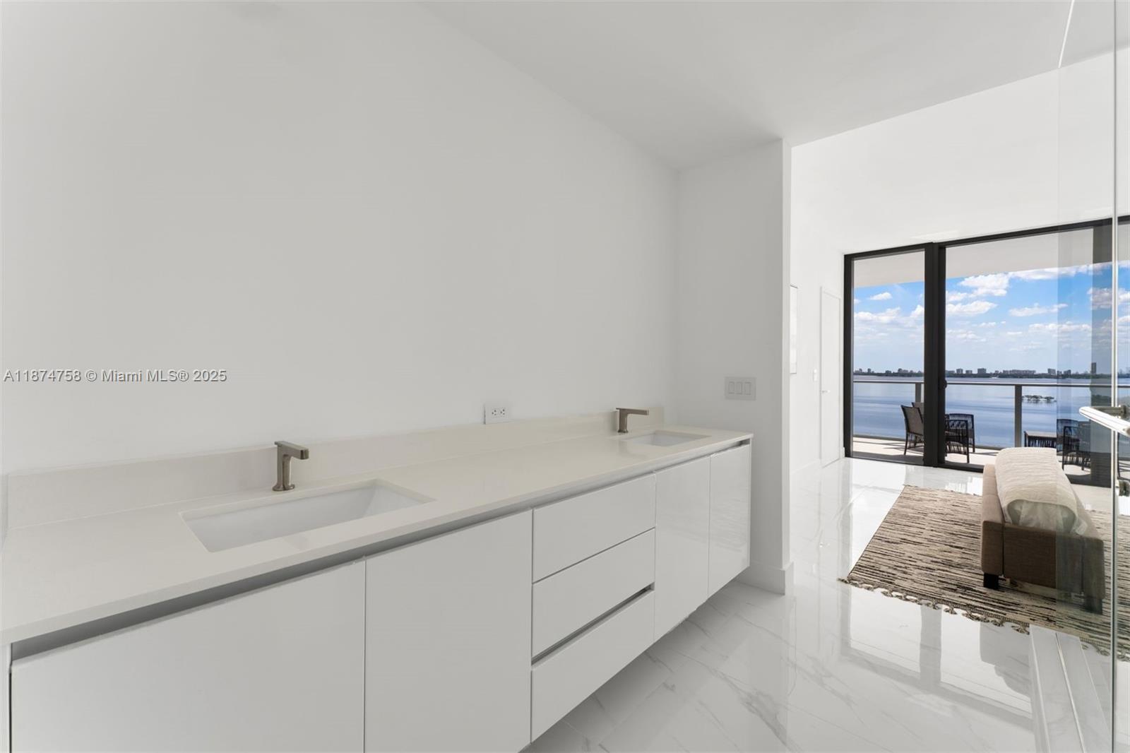 700 Northeast 24th Street, Unit 1005 Miami, FL 33137 - Photo 11 of 18 a bathroom with a double vanity sink and mirror