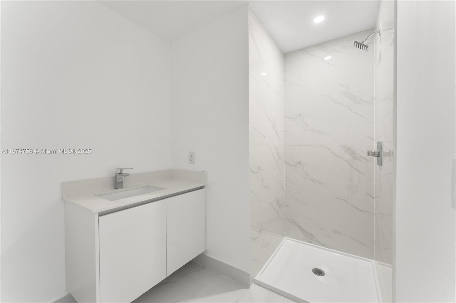 700 Northeast 24th Street, Unit 1005 Miami, FL 33137 - Photo 13 of 18 a bathroom with a sink toilet and shower