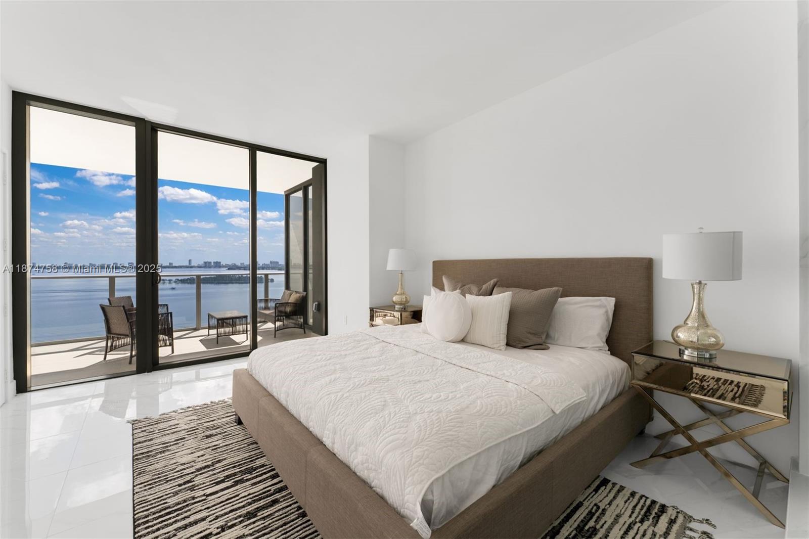 700 Northeast 24th Street, Unit 1005 Miami, FL 33137 - Photo 6 of 18 a bedroom with a large bed and a large window