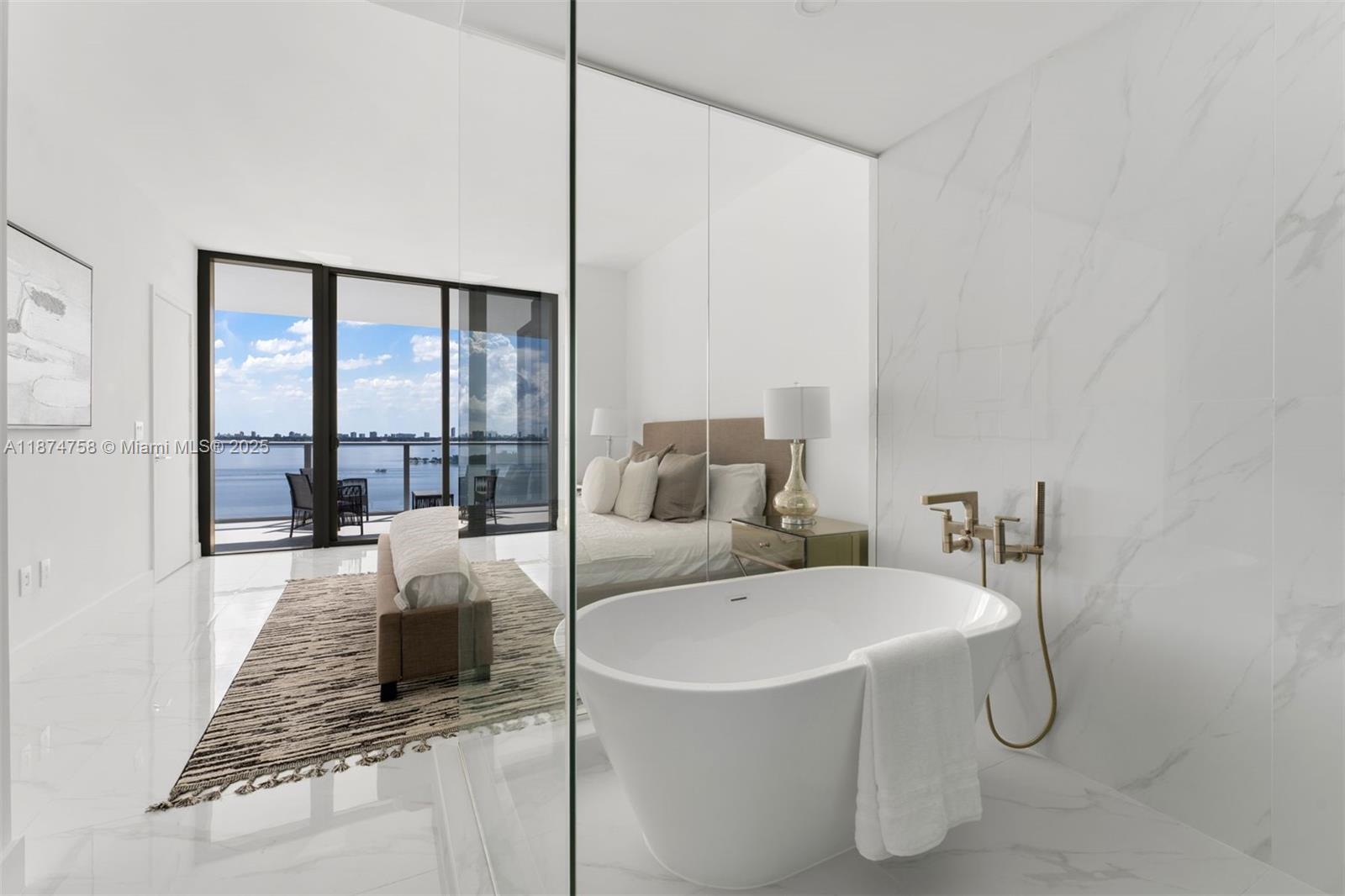 700 Northeast 24th Street, Unit 1005 Miami, FL 33137 - Photo 7 of 18 a spacious bathroom with a granite countertop sink and a mirror