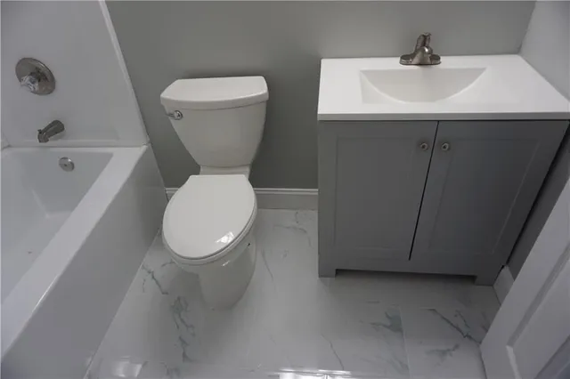 a bathroom with a toilet a sink and a bathtub