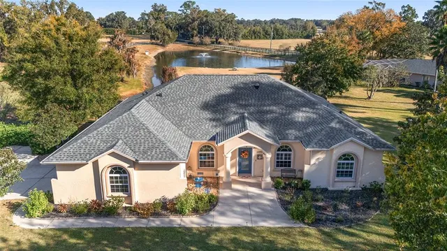 a view of house with garden and lake view