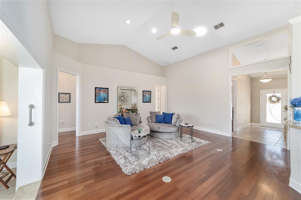 8942 Southwest 8th Street Ocala, FL 34481 - Photo 16 of 59 a living room with furniture and wooden floor