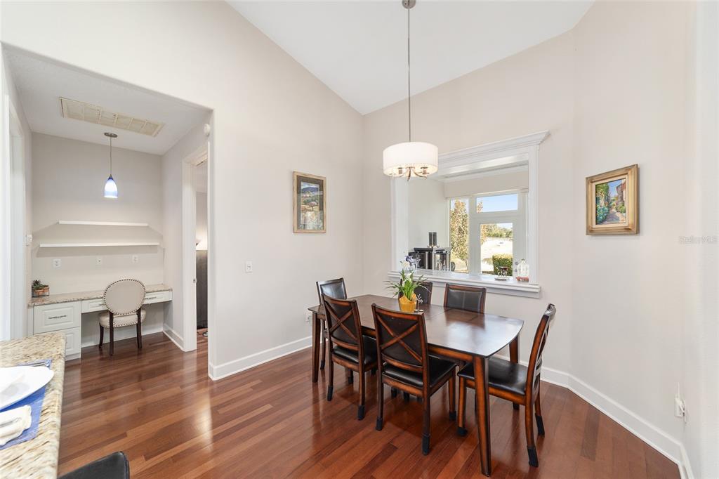 8942 Southwest 8th Street Ocala, FL 34481 - Photo 18 of 59 a view of a dining room with furniture wooden floor and chandelier