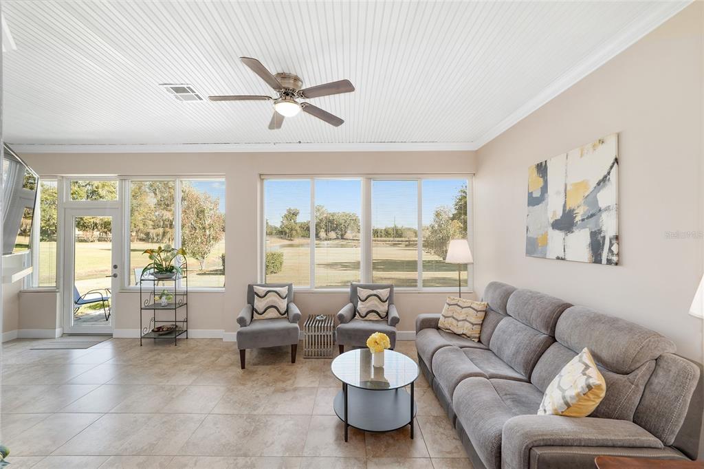 8942 Southwest 8th Street Ocala, FL 34481 - Photo 46 of 59 a living room with furniture and a large window with garden view