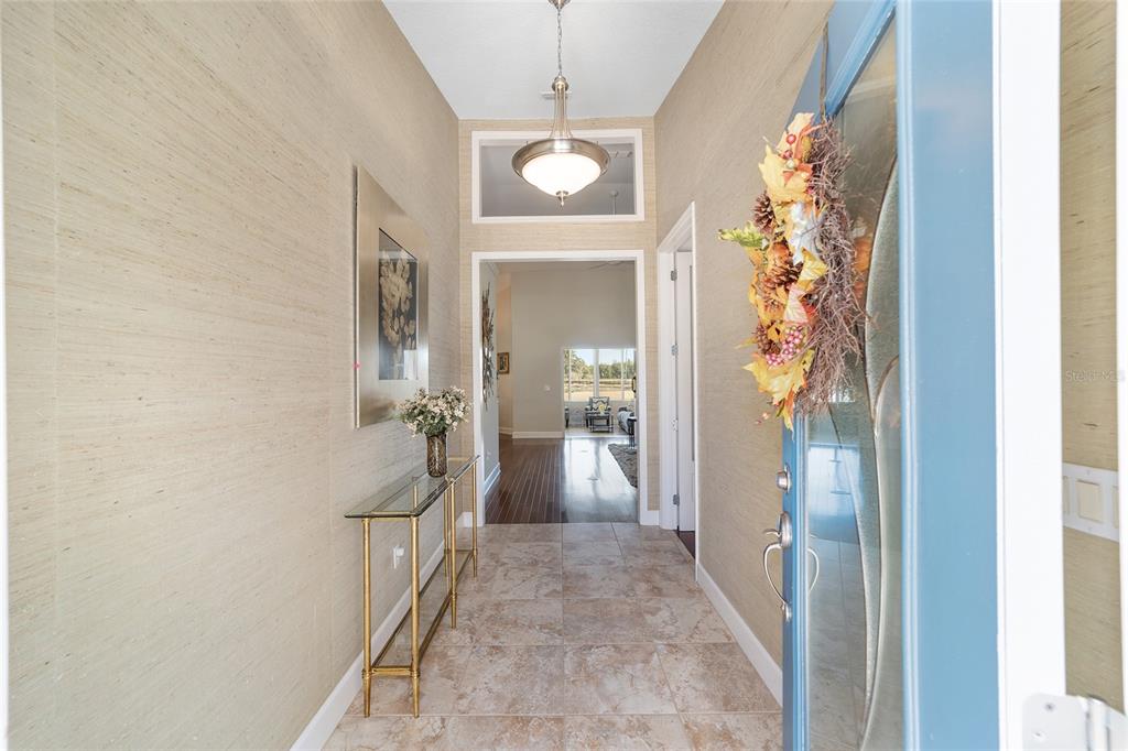 8942 Southwest 8th Street Ocala, FL 34481 - Photo 9 of 59 a view of a hallway with wooden floor and stairs
