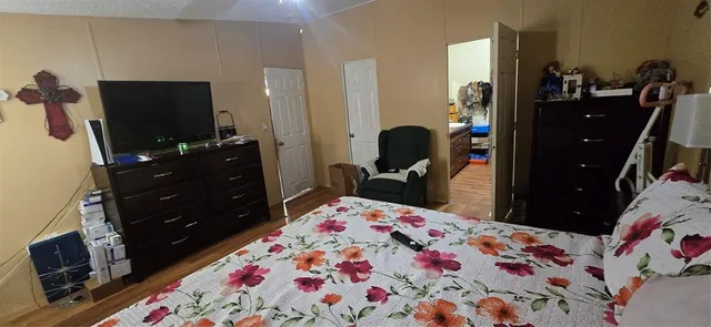 a bed room with a bed and a television