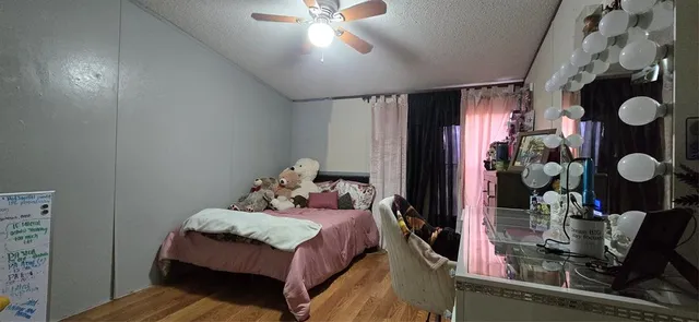 a bedroom with bed and a mirror