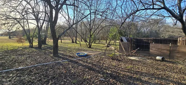 a backyard of a house with barbeque oven table and chairs