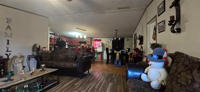 a living room with lots of furniture and wooden floor