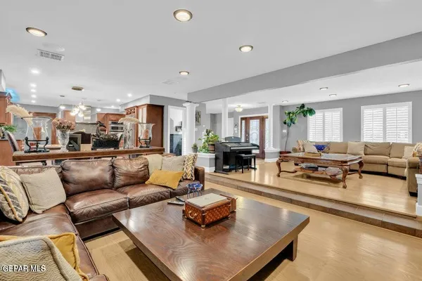 a view of a a dining room with furniture window and wooden floor