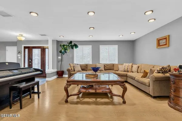 a living room with furniture and a wooden floor