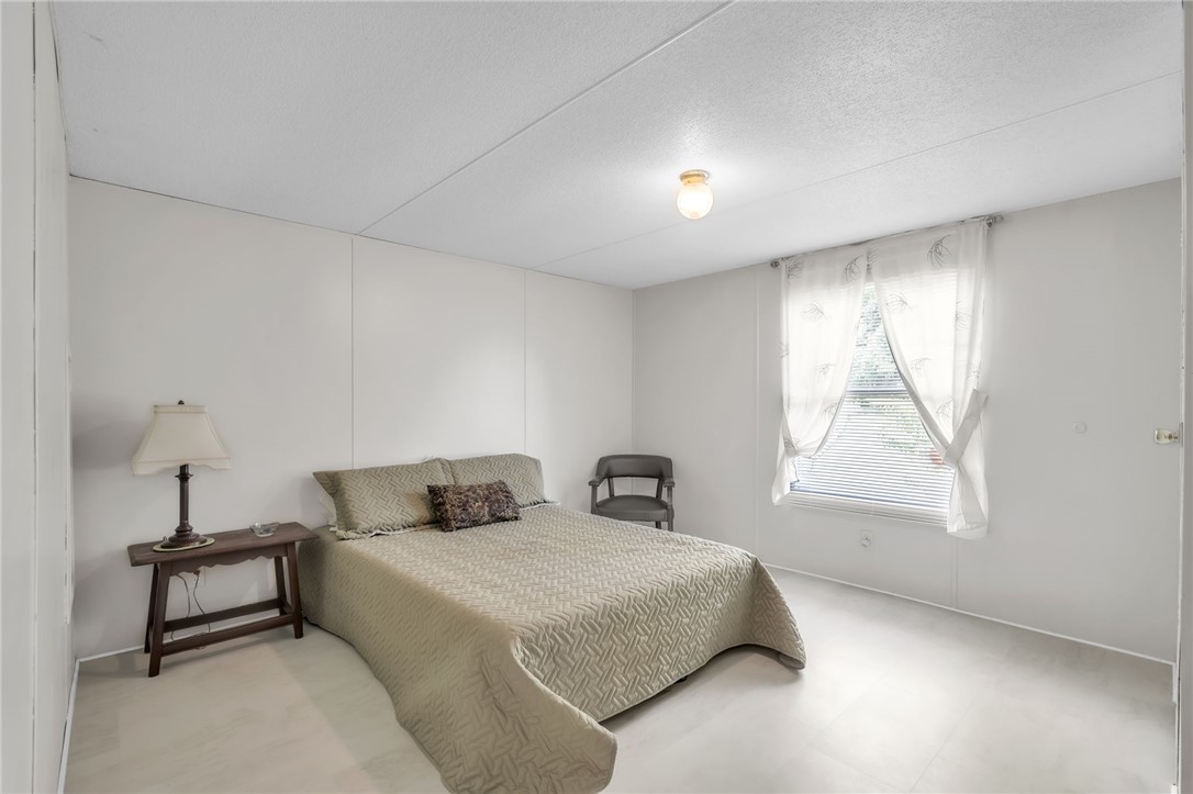 506 Charlies Creek Road Iva, SC 29655 - Photo 17 of 28 A well-lit bedroom features pristine walls and durable flooring, creating a serene retreat.