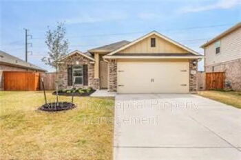 12313 Caldera Way Manor, TX 78653 - Photo 11 of 11 Single-story home featuring a brick and siding facade, an attached two-car garage, and a concrete driveway