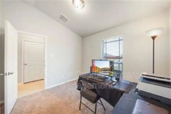 12313 Caldera Way Manor, TX 78653 - Photo 7 of 11 Room with neutral wall paint and carpeted flooring