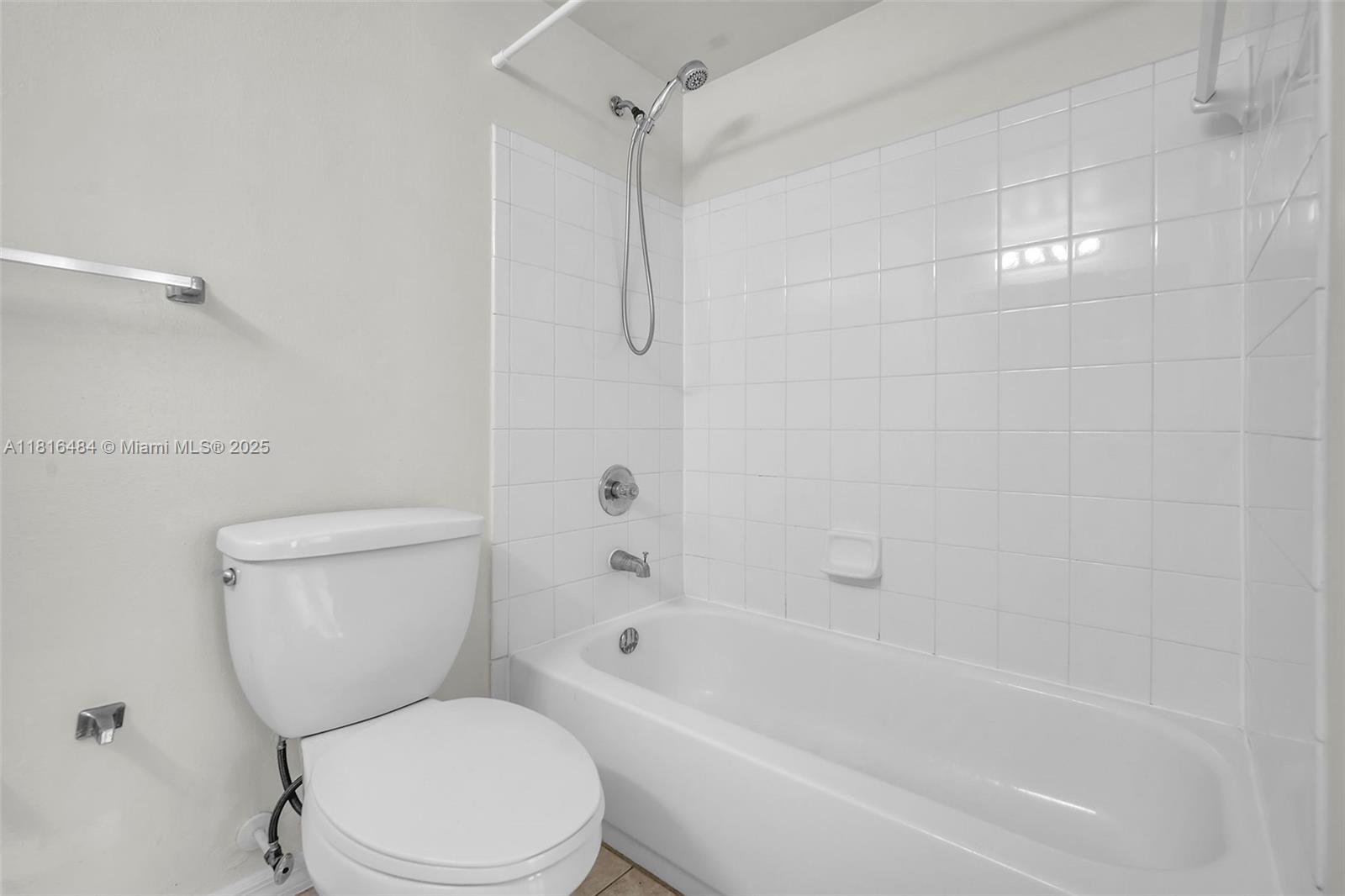 2474 Centergate Drive, Unit 101 Miramar, FL 33025 - Photo 17 of 28 a white toilet sitting next to a bath tub and a shower
