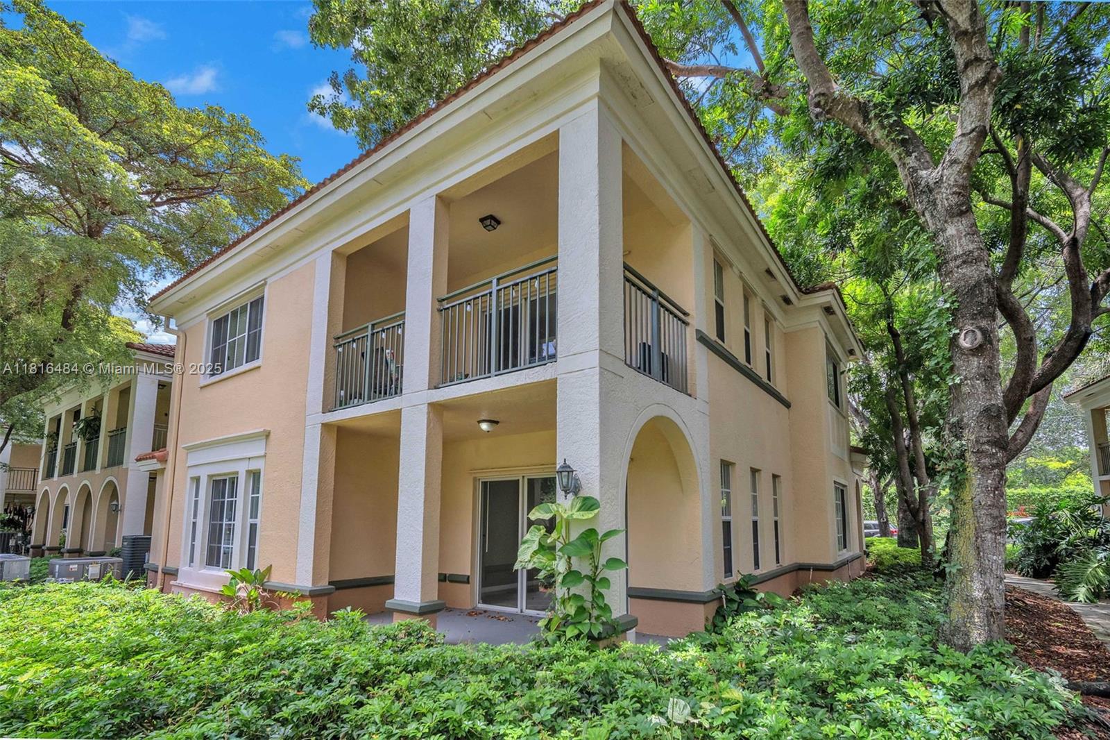 2474 Centergate Drive, Unit 101 Miramar, FL 33025 - Photo 24 of 28 a view of a house with a yard and plants