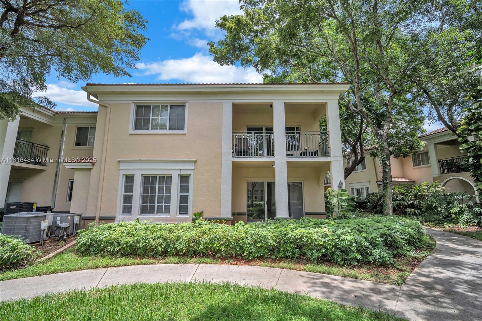 2474 Centergate Drive, Unit 101 Miramar, FL 33025 - Photo 26 of 28 front view of a house with a yard