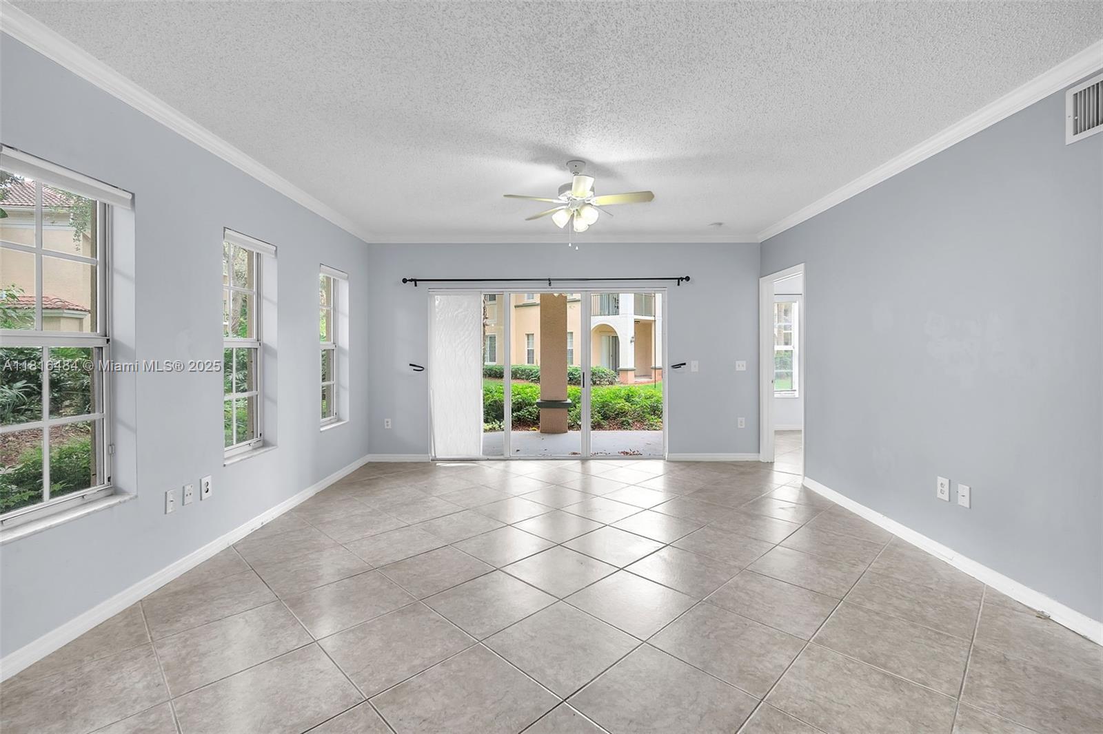 2474 Centergate Drive, Unit 101 Miramar, FL 33025 - Photo 3 of 28 a view of a room with windows and chandelier
