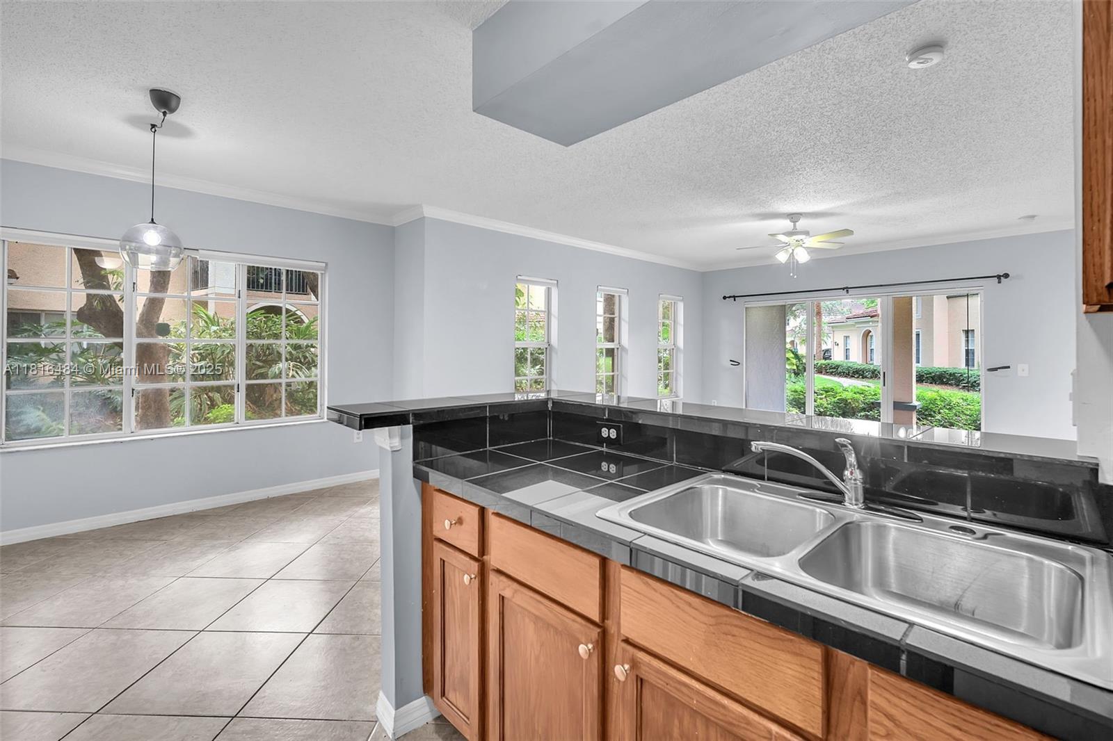 2474 Centergate Drive, Unit 101 Miramar, FL 33025 - Photo 5 of 28 a kitchen with a sink and a large window