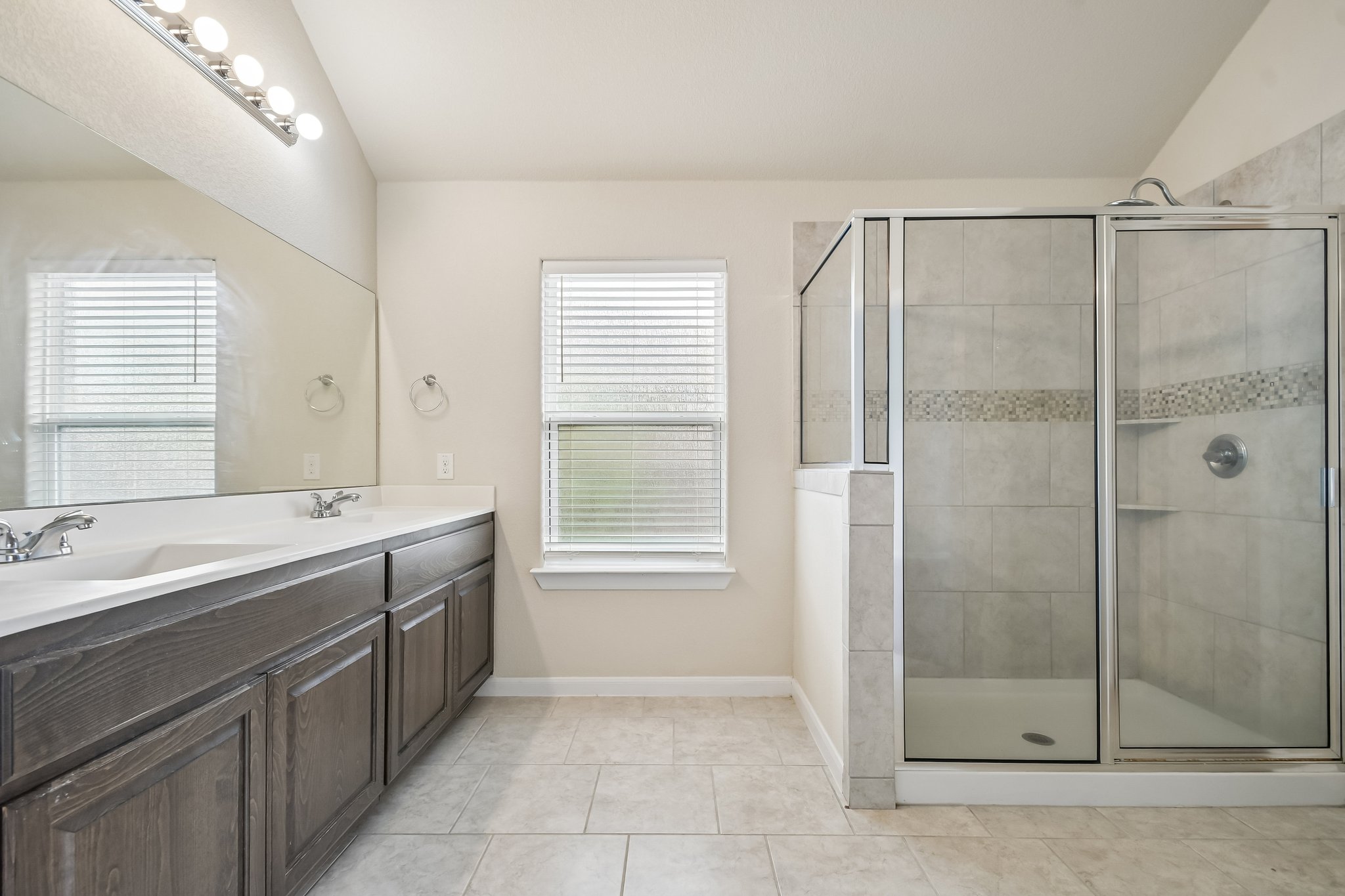 280 Rimrock Court Bastrop, TX 78602 - Photo 13 of 34 Clean lines and a spacious dual vanity highlight this tile-floored washroom.