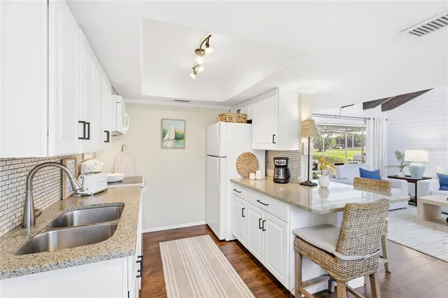 a bedroom with a bed and painting on the wall