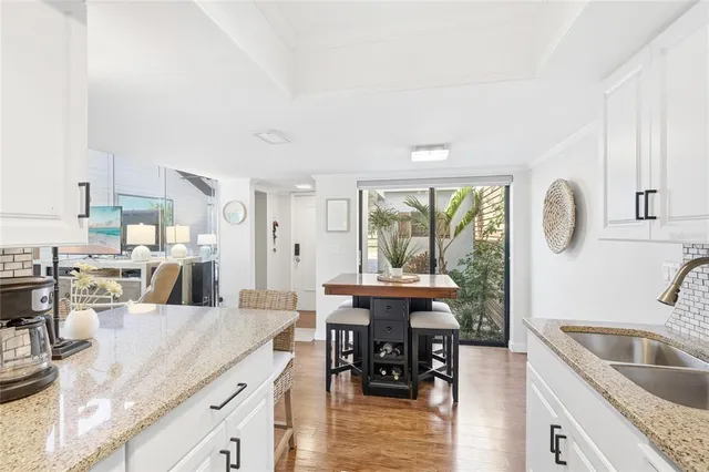 a bathroom with a granite countertop sink a toilet and a mirror