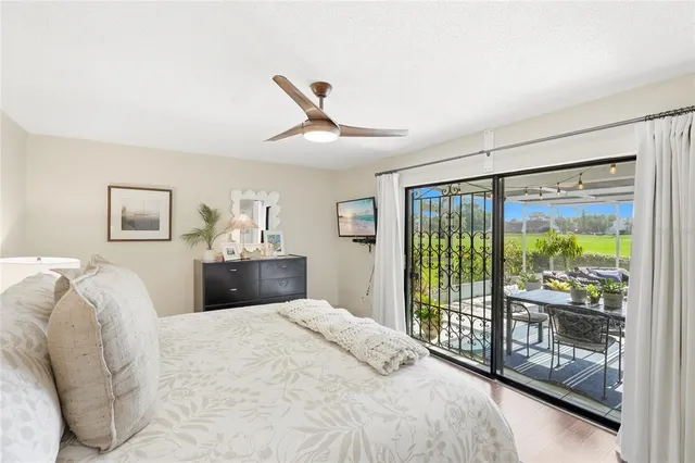 a bedroom with a large bed and a chandelier