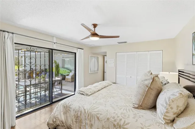 a bedroom with a bed and a painting on the wall