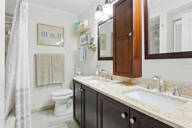 a view of a patio with table and chairs potted plants with wooden floor and fence