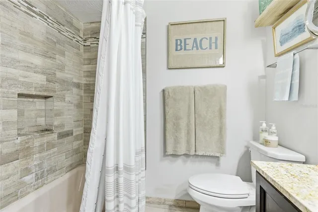 a view of a patio with lawn chairs floor to ceiling window and an outdoor view