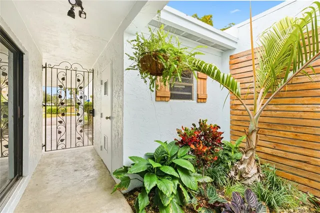 a living room with furniture kitchen view and a large window